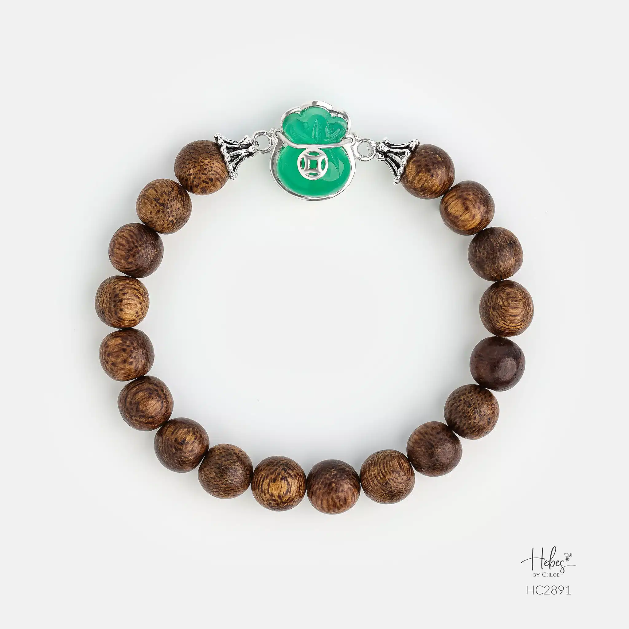 Gentle jade tones ripple from the central money bag pendant of this beautiful agarwood bracelet